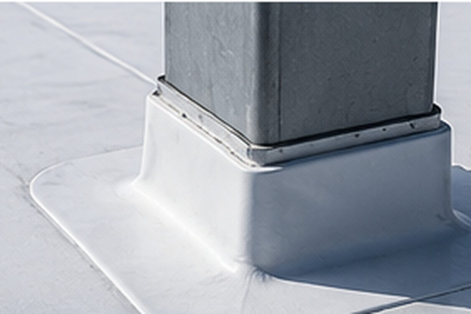 Membrane flashed up around a rooftop curb on an industrial roof